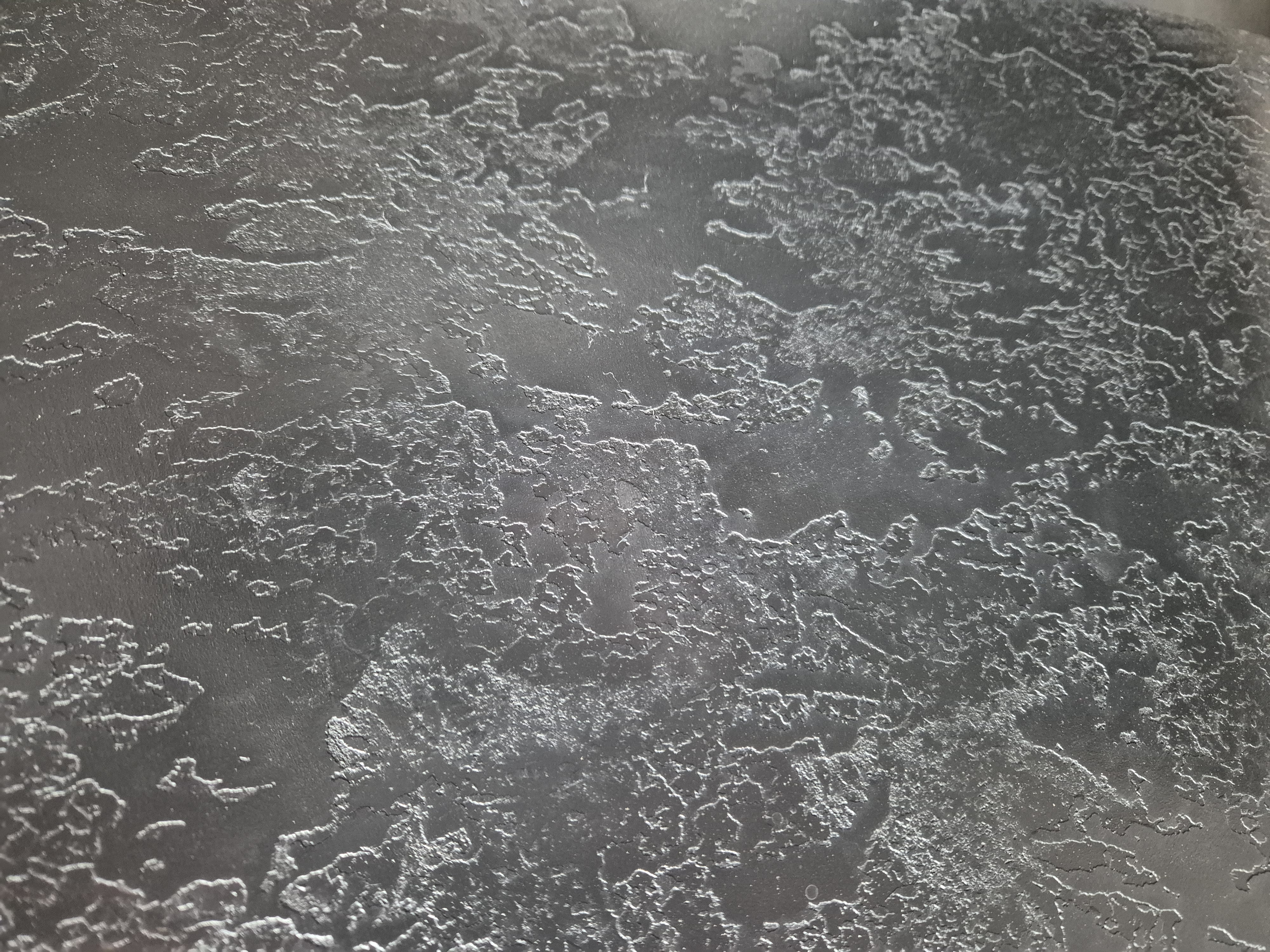 Dark charcoal textured decorative plaster wall