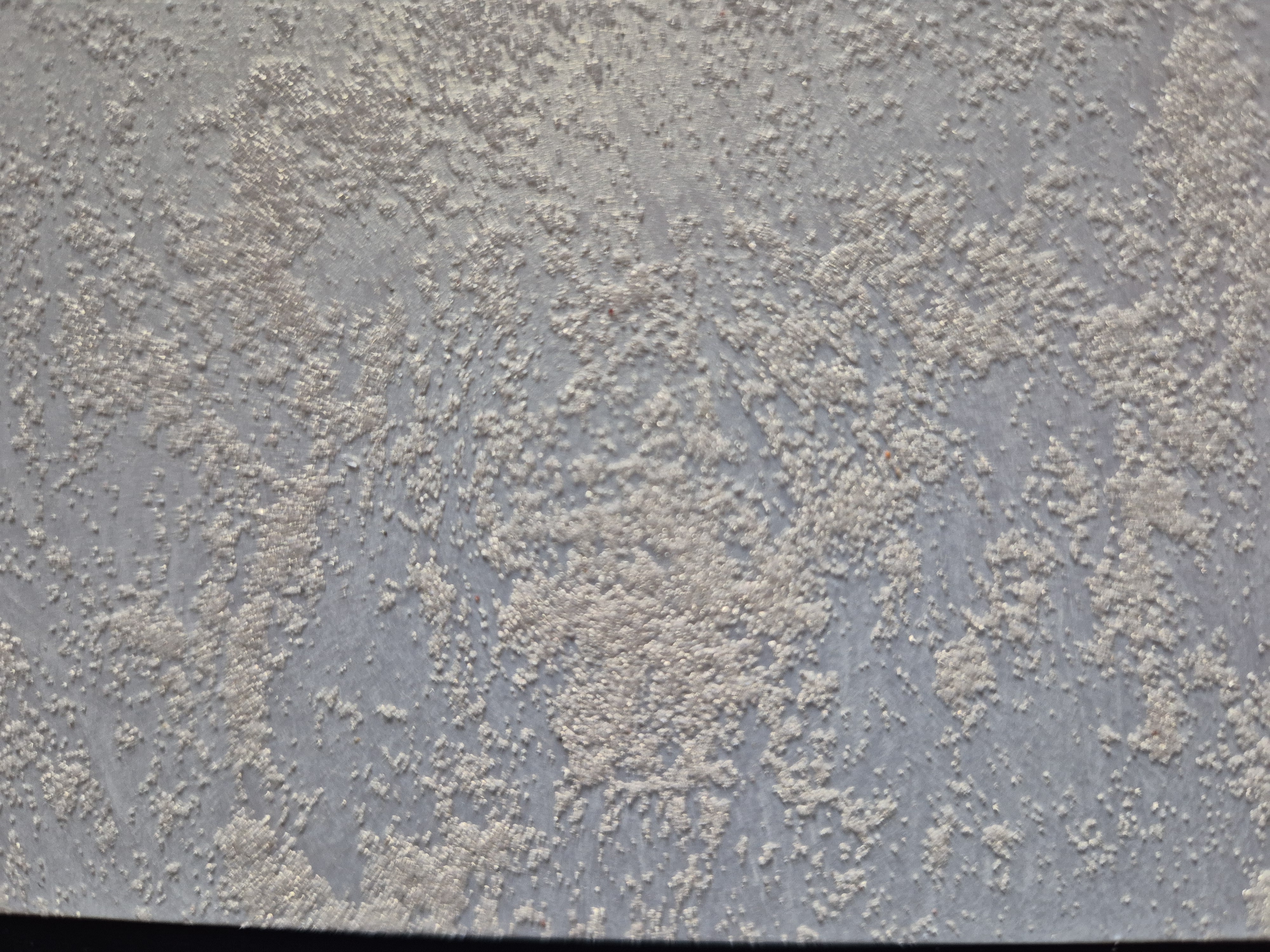 Textured grey decorative plaster finish close-up