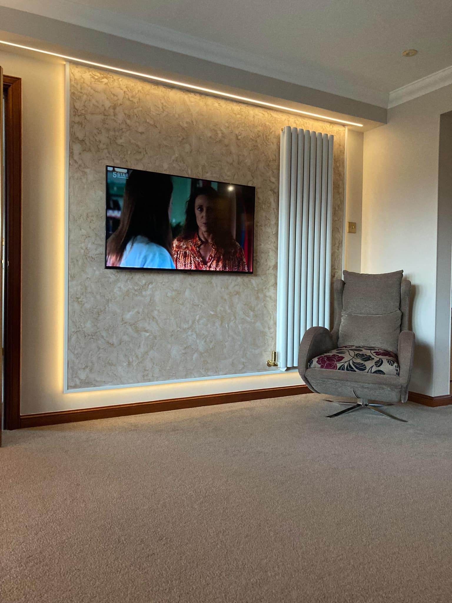 Venetian plaster feature wall with LED backlighting in a luxury living room in Moray, Scotland