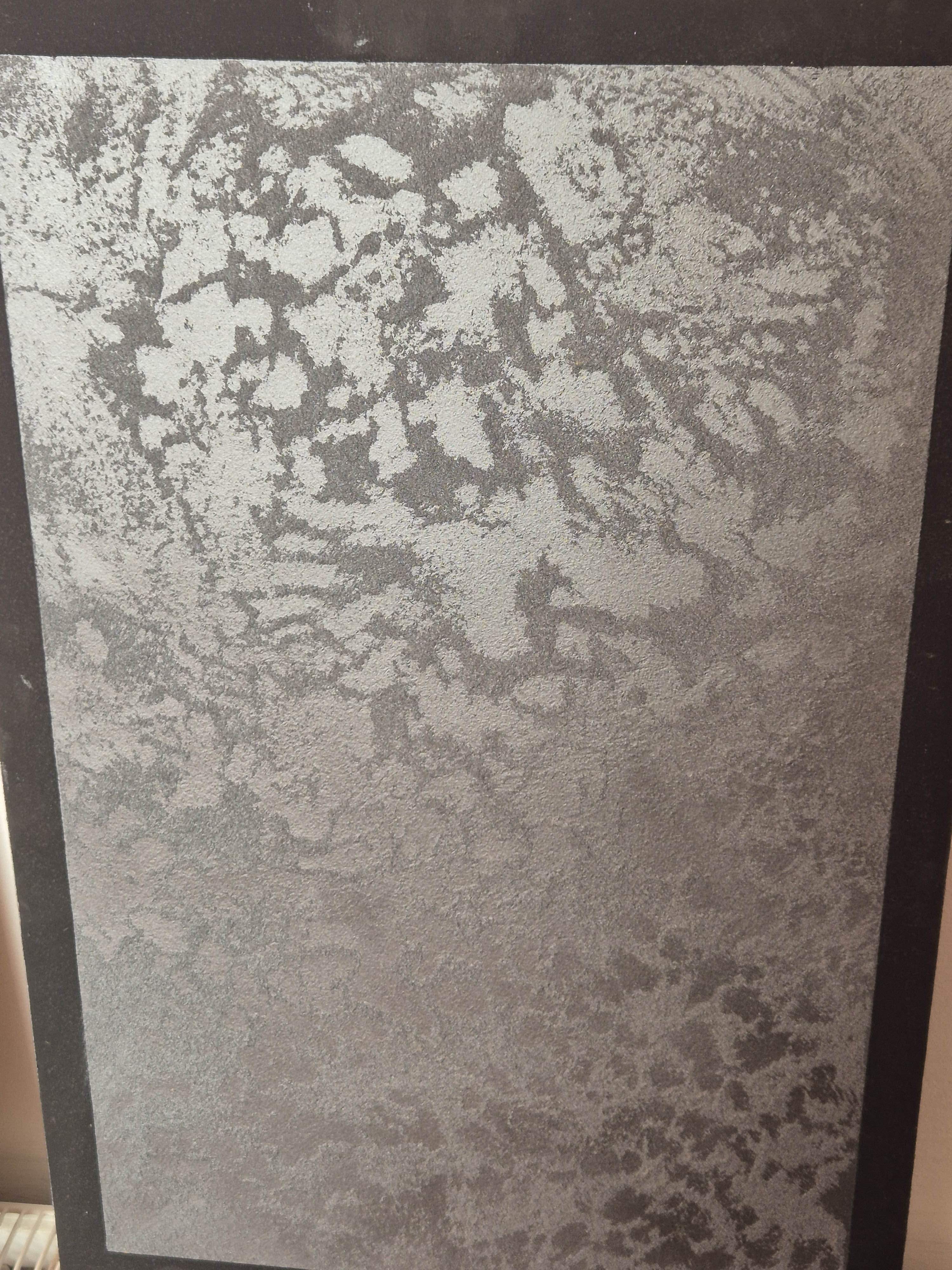 Dark grey textured decorative plaster sample board